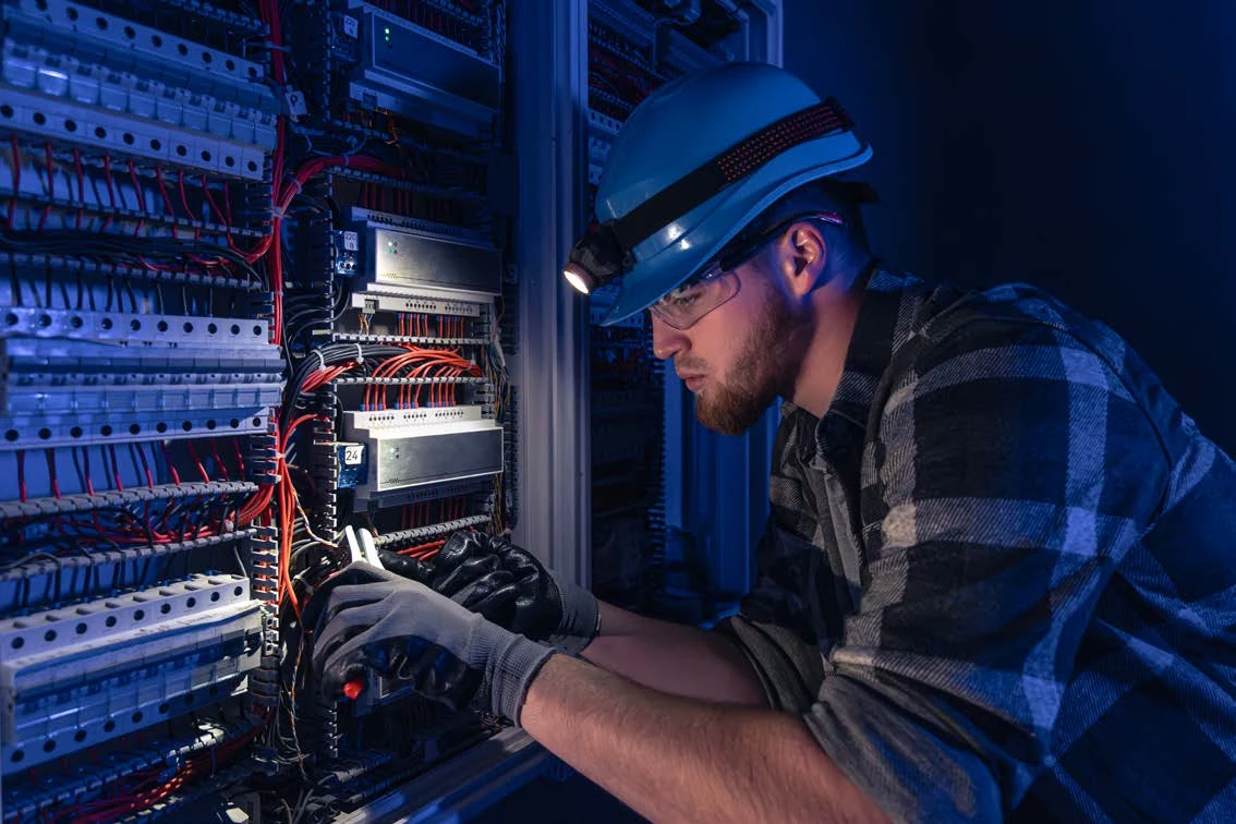 Technician reviewing electrical equipment, from KelTech’s supplied brochure